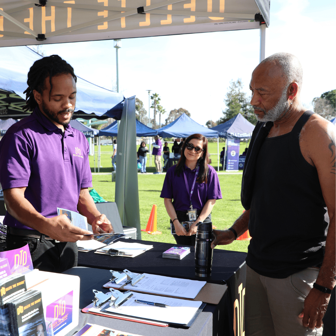 intern explaining a flyer to an adult