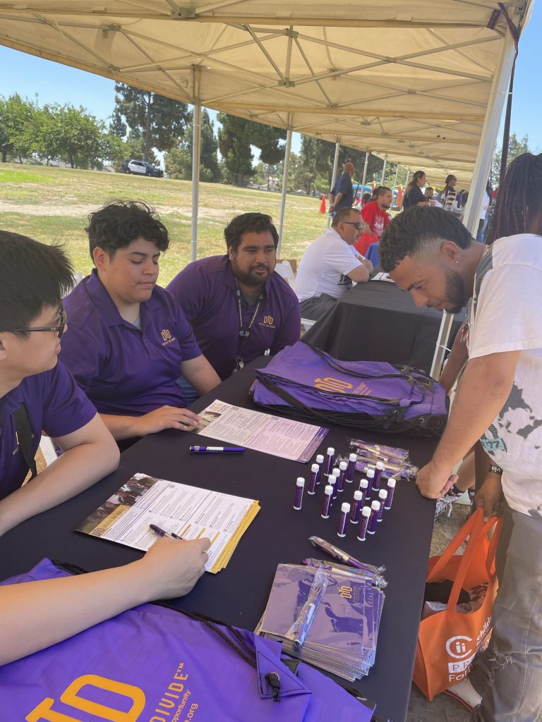 3 DTD interns informing a father on our program