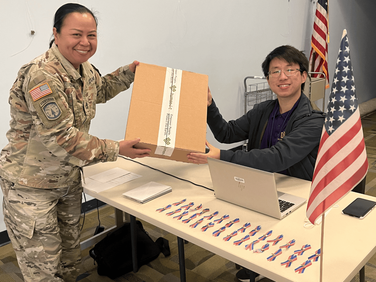 intern handing out laptop