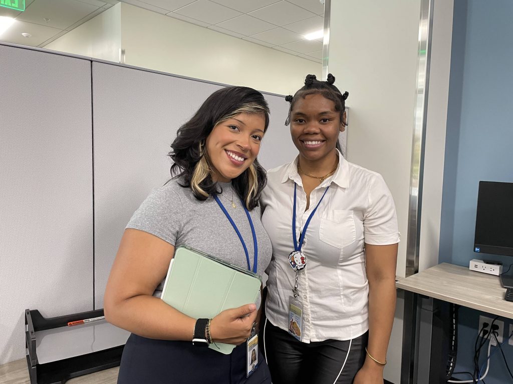 Two smiling interns next to each other