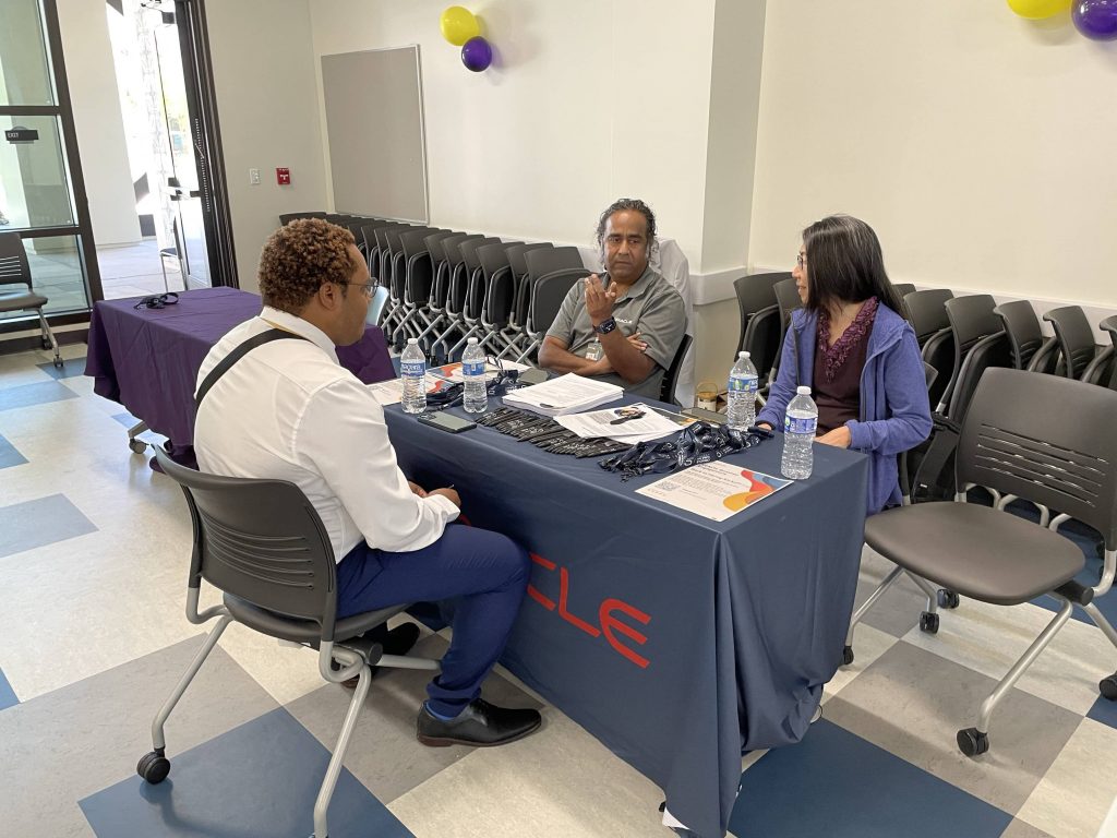 Two oracle recruiters talking to an interviewee.