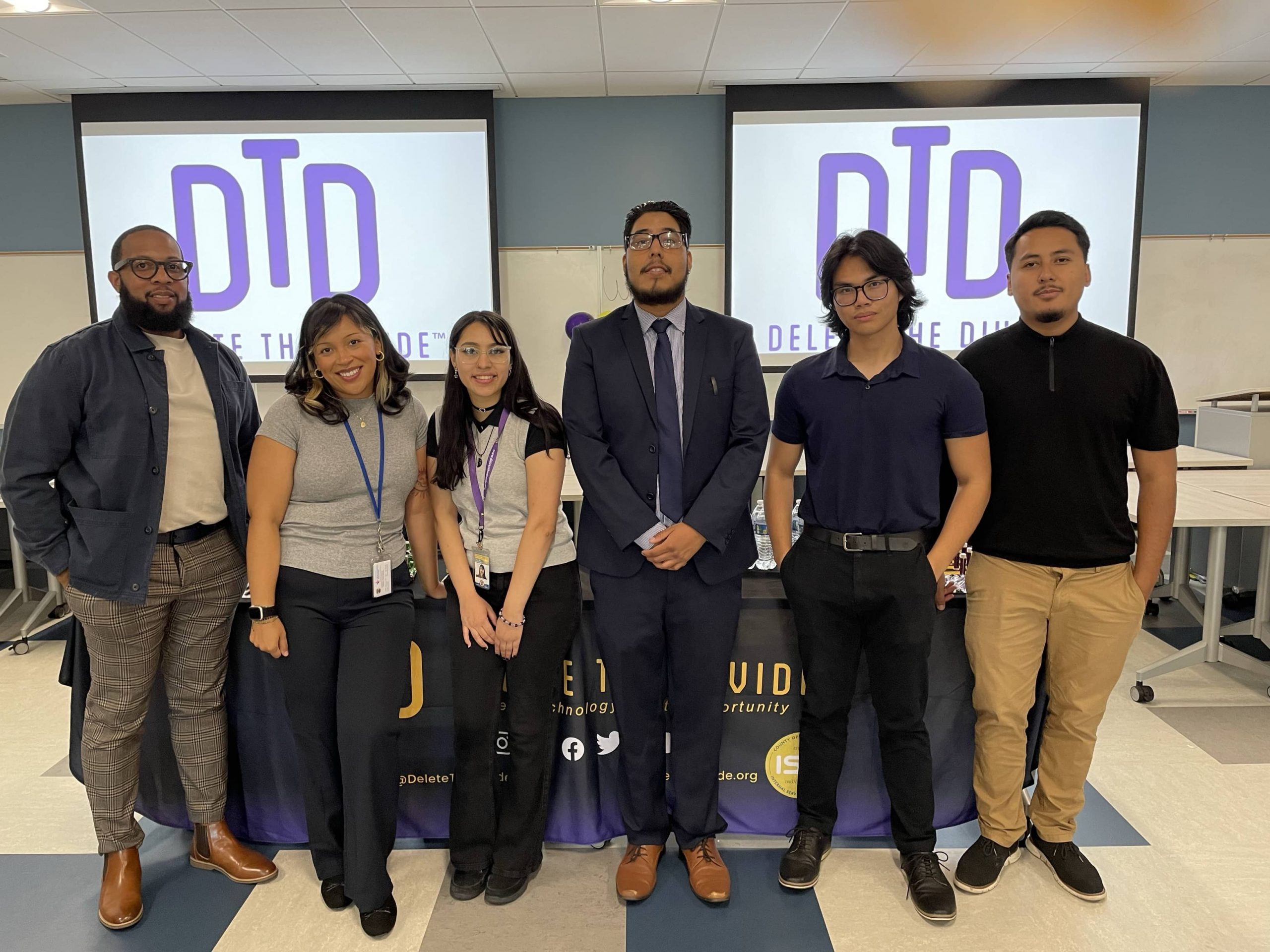 Several interns standing in front of the Delete the Divide table