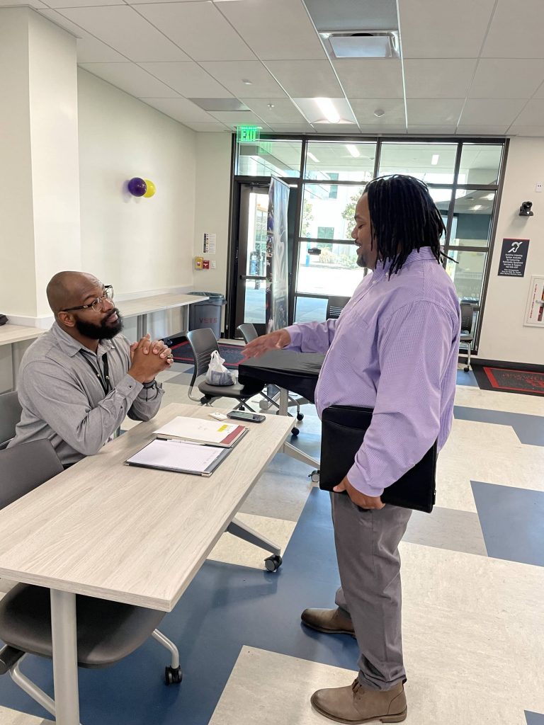 Man in formal clothes talking to recruiter