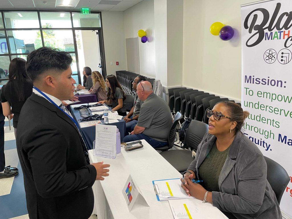 one male intern being interviewed by one female recruiter