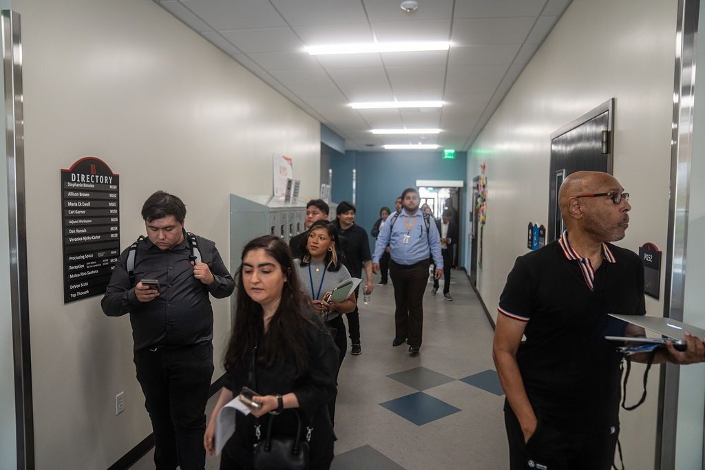 Men and women walking down a hallway