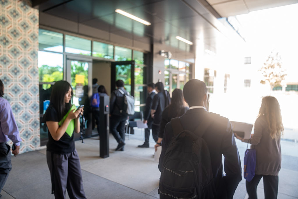 People entering job recruitment fair for interns